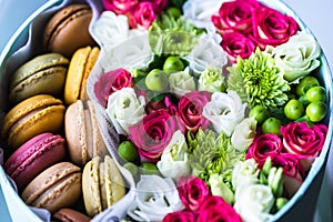 Flower box with flowers and macarons composition closeup