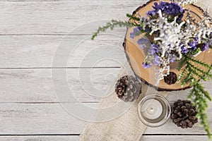 Flower and candle decoration on wood table with panel banner