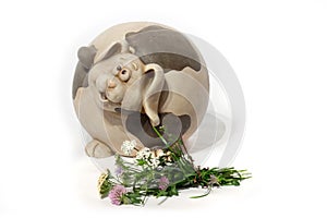 Flower with ceramic dog on white background