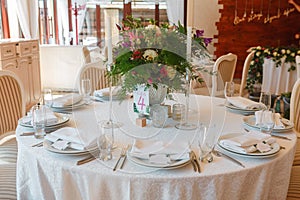 Flower composition and candles in the restaurant. Wedding dinner