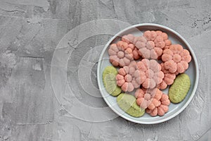 Flower cookies on a plate on a gray background . Spring holidays cooking concept