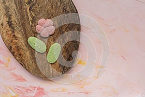 Flower cookies on a wooden board on a pink background . Spring holidays cooking concept