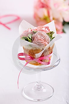 Flower cupcakes on white background. Beautiful sponge cup cakes decorated with buttercream roses