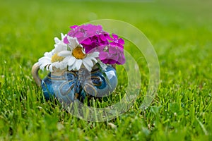 flower decoration in a cup in a meadow