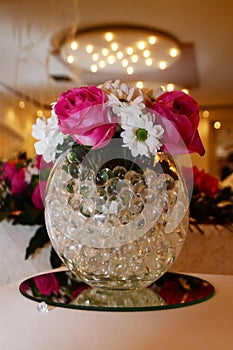 Flower decoration on the table with glass perls