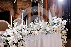 Flower decoration of wedding tables. Banquet table setting and decoration.