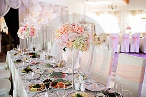 Flower decoration of wedding tables. Banquet table setting and decoration. Cutlery on the table.