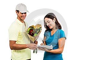 Flower delivery man taking signature of beautiful woman