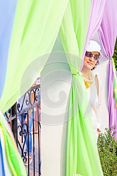 Flower Festival. A mature woman on the stage, which is decorated with bright fabrics and flower pots