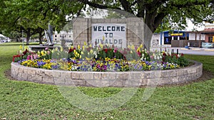 Flower Garden and Welcome to Uvalde sign at the corner of 4th Street and US Highway 90 in Uvalde, Texas.