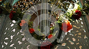 Flower garland on the gates peeking into sunlit garden