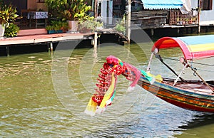 Flower garlands hung on Thai long tail boat prow for the offering to Mae Ya Nang Goddess