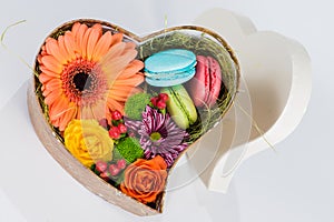 Flower gerbera and macaroon in heart shaped box