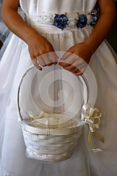 Flower girl holding a peddle basket