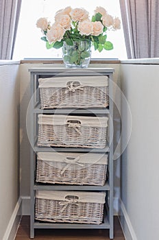 Flower in glass vase on wooden cabinet