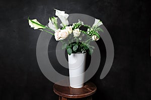 Flower Ikibana on a black background, bouquet in a white vase