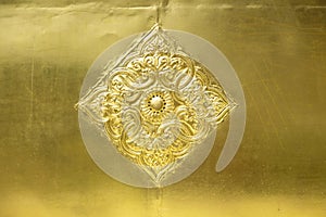 flower and leaf pattern in Thai Lanna style carved on gold metal plate background