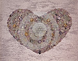 Flower of life in heart shaped from amethyst crystals, luxury painted background