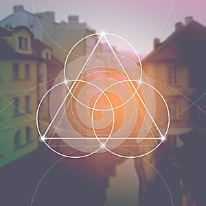 Flower of life - the interlocking circles ancient symbol in front of blurred photorealistic nature background. Sacred geometry - m