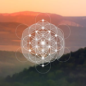 Flower of life sacred geometry illustration with intelocking circles and light dots in front of photographic background. Hipster