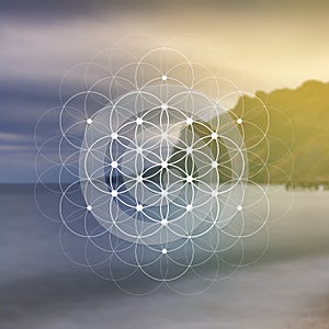 Flower of life sacred geometry illustration with intelocking circles and light dots in front of photographic background. Hipster