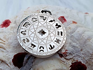 Zodiac sign horoscope star signs jewelry on shell photo