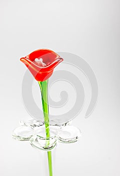 Flower made of glass in red and blue color in vase on grey background,Template for add text