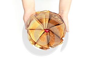 The flower made of homemade pancakes in childÃ¢â¬â¢s hands on white background. Maslenitsa, spring festival concept. Russian