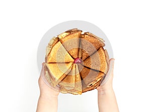 The flower made of homemade pancakes in childÃ¢â¬â¢s hands on white background. Maslenitsa, spring festival concept. Russian