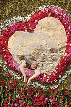 Flower madness. Girl in frame of roses on background of heart