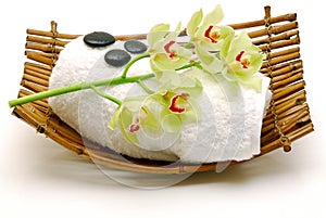 Flower and massage stone on towel isolated