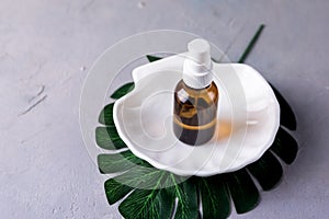 Flower Oil in Cosmetic Bottles on Gray Background Cosmetic or Spa Concept Horizontal Copy Space