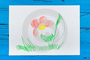 A flower is painted with red and green pencils