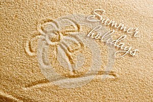 The flower is painted on the sand and the inscription is summer holidays. Beach background. View from above. The concept of summer