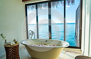 Flower petals in a hot bathtub by the ocean