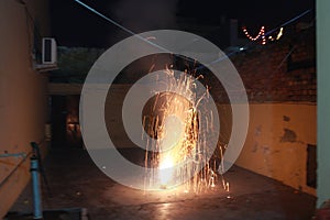 A Flower Pot fire cracker is mostly burnt on the night of Diwali releasing a spectacular outburst of sparkles