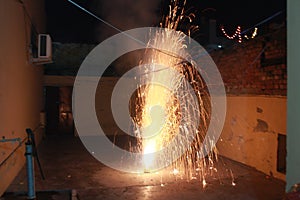 A Flower Pot fire cracker is mostly burnt on the night of Diwali releasing a spectacular outburst of sparkles