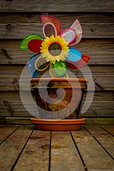 Flower Pot with a toy windmill and a sunflower.