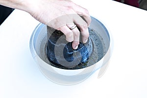 Flower pot upside down in a dish full of water