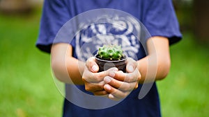 Flower pots on the child`s hands