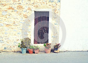 flower pots and old wooden door on small cozy street