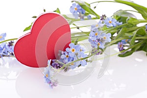 Flower with red wooden heart