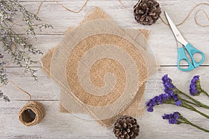 Flower and sackcloth decoration on wood table with panel banner