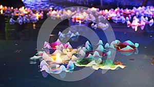 Flower-shaped candle burning in the spirit pool of chinese temple