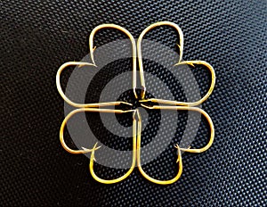 Flower-shaped design with fishhooks on a black surface photo