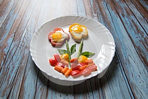 Flower shaped food art created with poach eggs, capsicums and vegetables photo