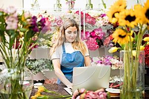 Flower shop owner using a computer