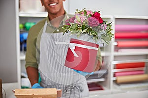 Flower store shopkeeper selling a roses pot