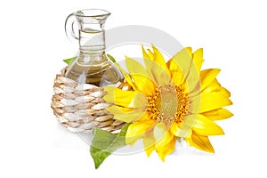 Flower of a sunflower and small bottle with the vegetable oil