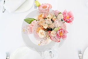 Flower table decorations for holidays and wedding dinner. Table set for holiday, event, party or wedding reception in